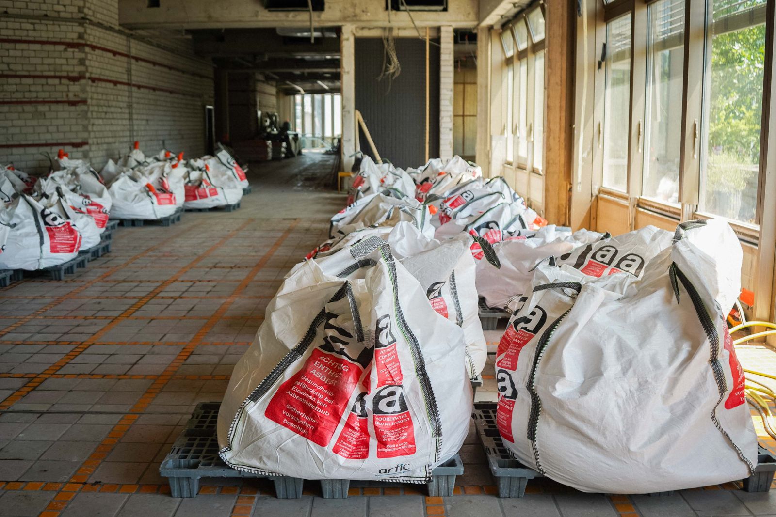 Gefüllte Big Bags mit sortenrein getrenntem Bauschutt in einem Bürogebäude